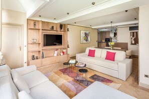 A modern living room with a sofa, coffee table, and entertainment unit.