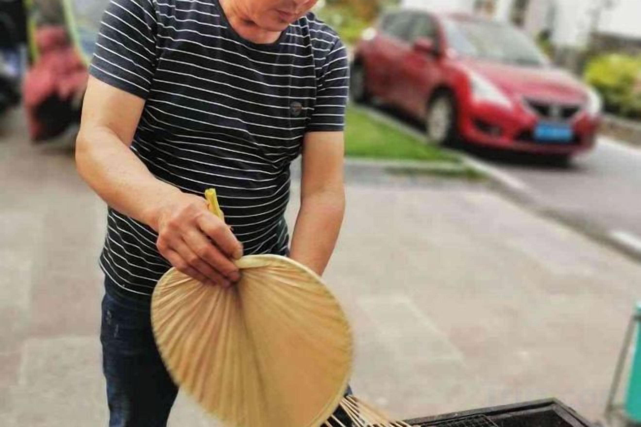 Eine Person hält einen runden, beigen Gegenstand.