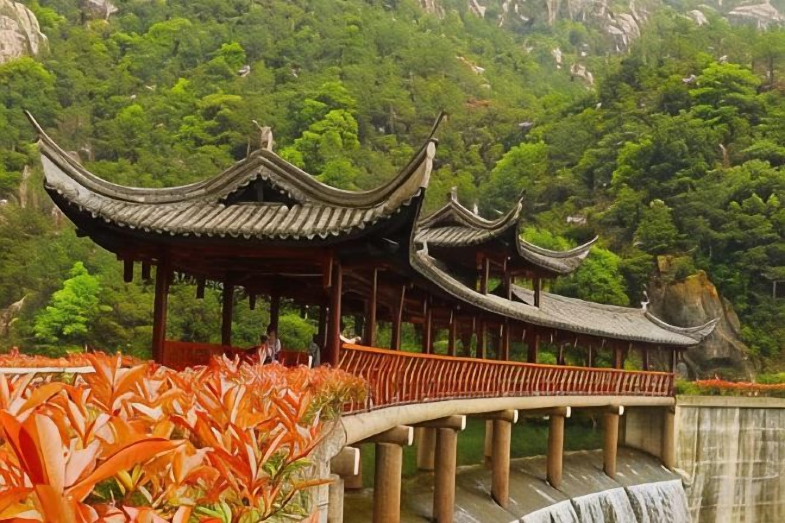 A traditional Chinese pavilion with a curved roof, situated on a stone bridge over a waterfall, surrounded by lush greenery.