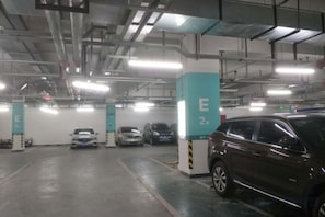 A multi-level parking garage with several cars parked.