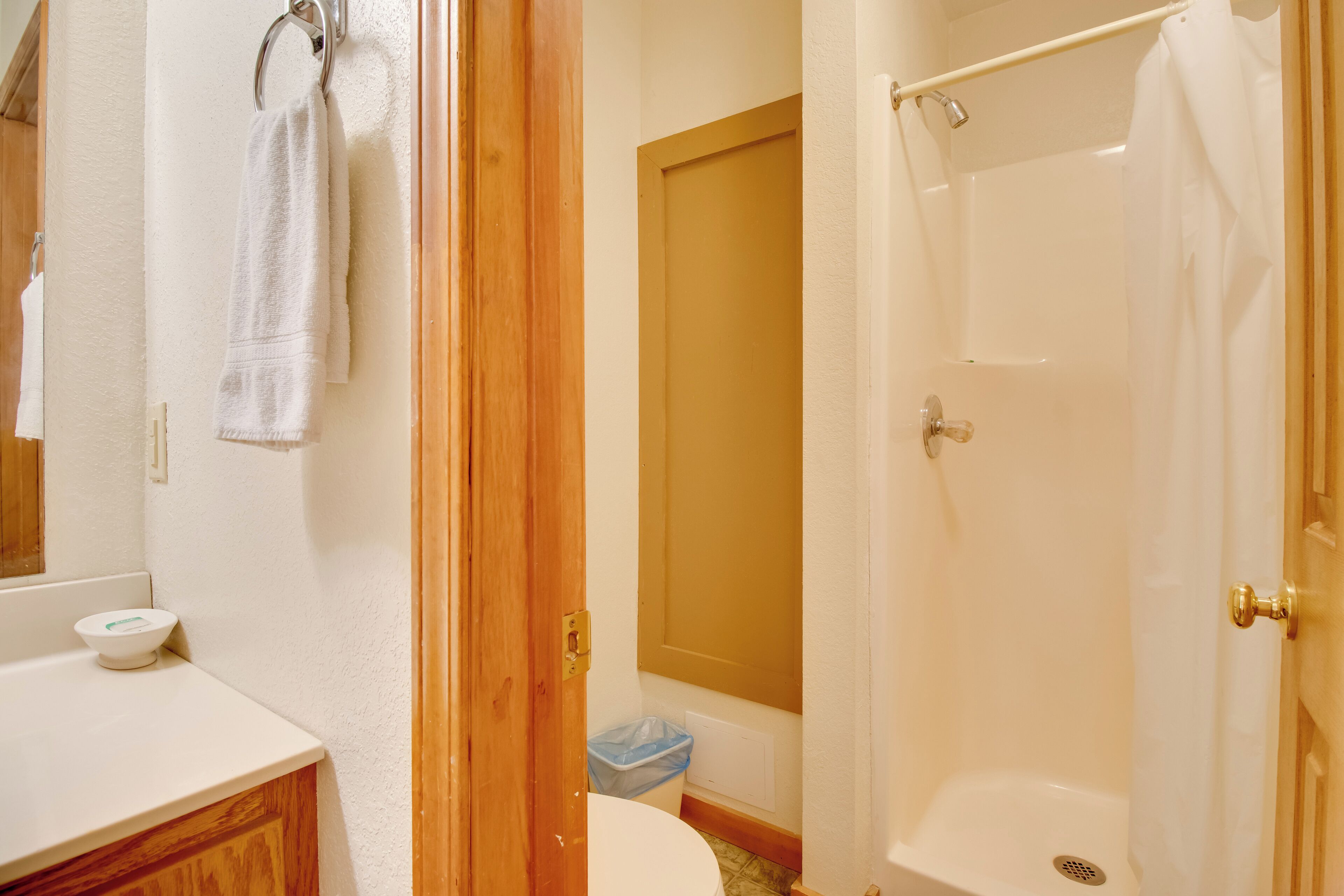 A bathroom with a toilet, sink, and shower.