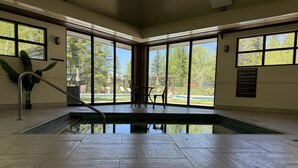 A large indoor pool with clear views of the outdoors through large windows. - Spacious 4,000 Sq Ft Riverfront Home | Game Room • Deck • 1.5 Miles to Keystone (Keystone)