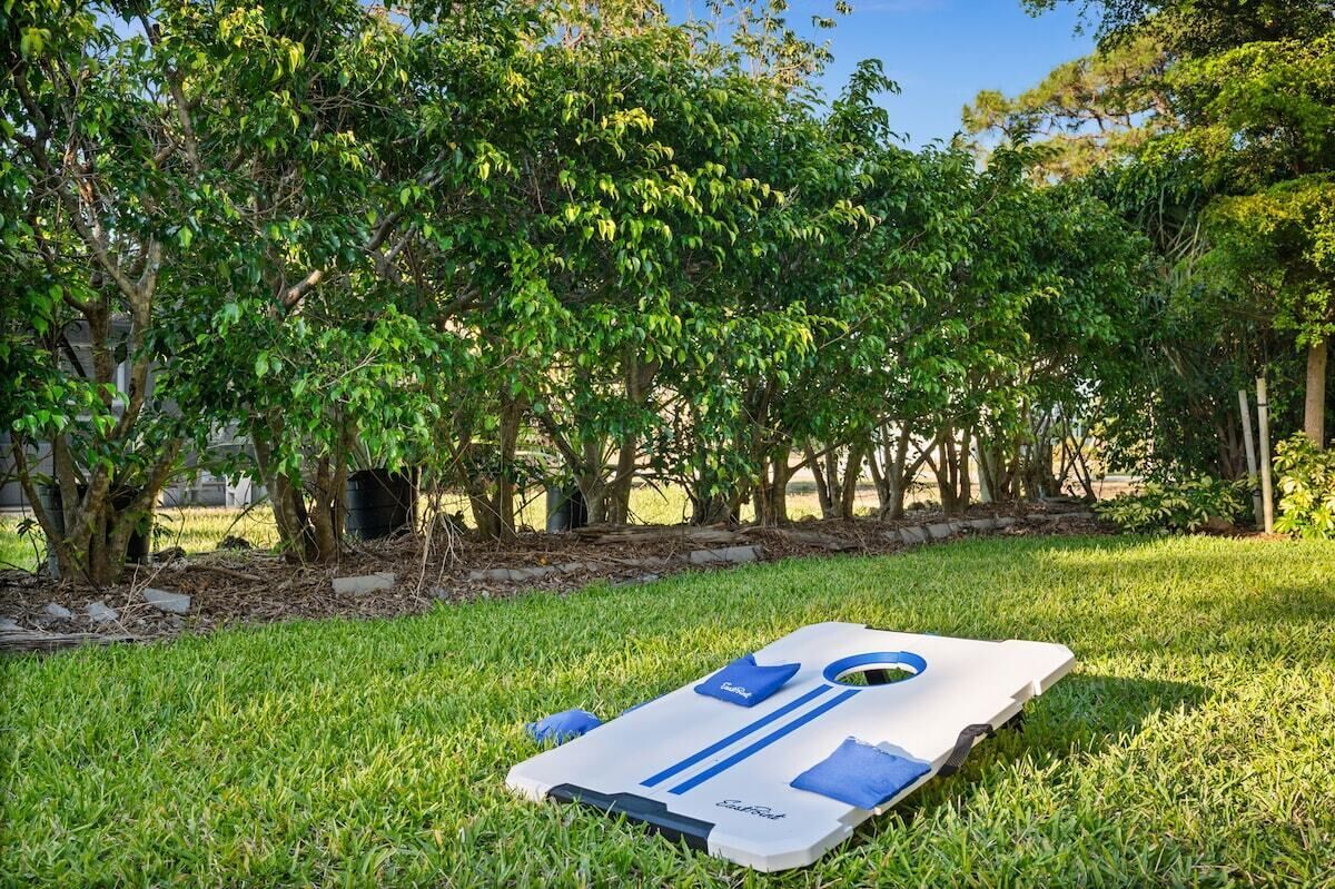 An outdoor area with a grassy surface and a white and blue floating device.