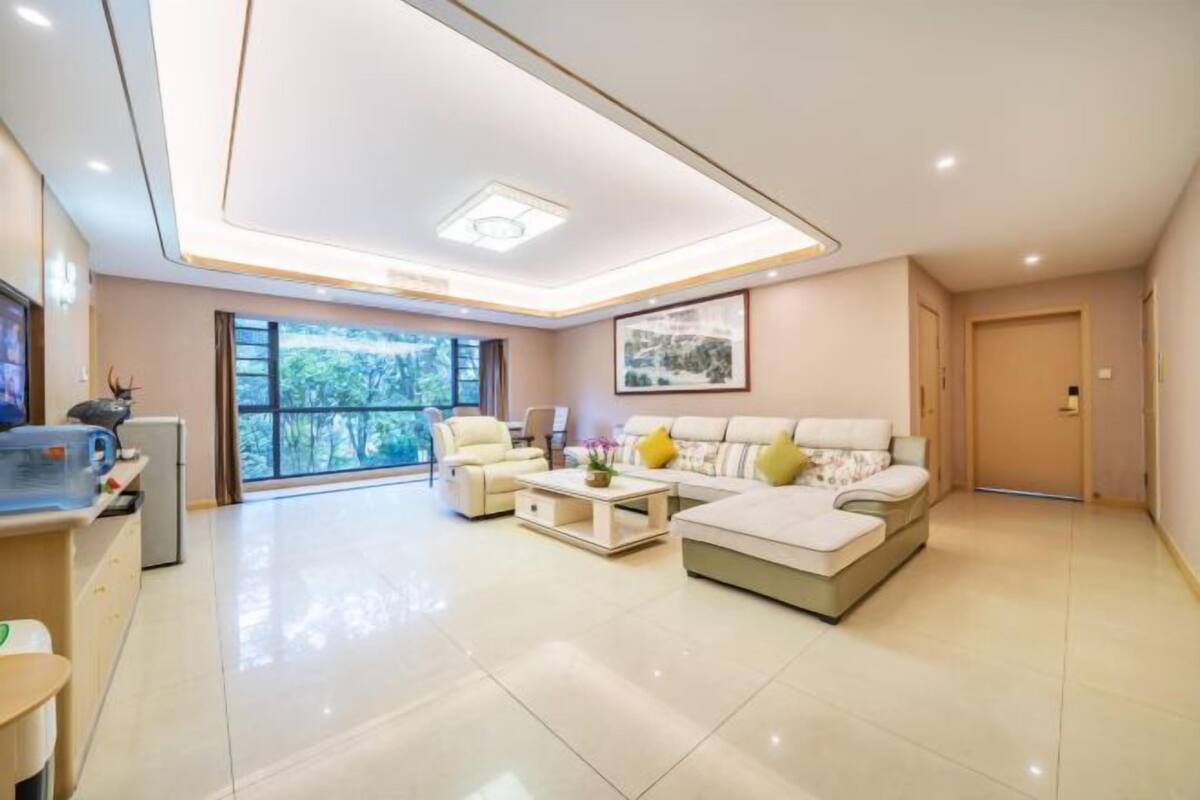 A modern living room with a sofa, coffee table, and a television.