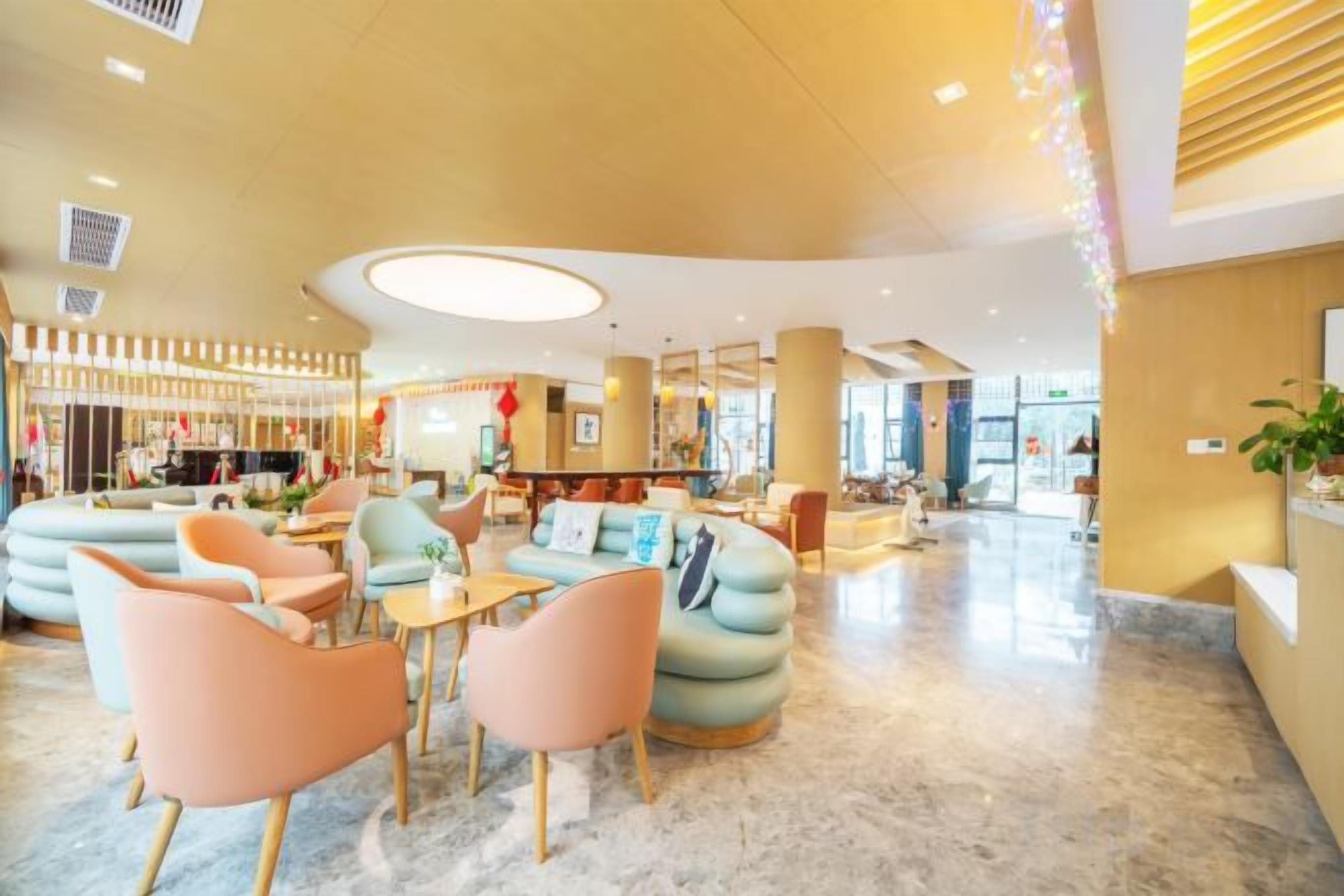 A spacious lobby with seating areas, a reception desk, and a bar.