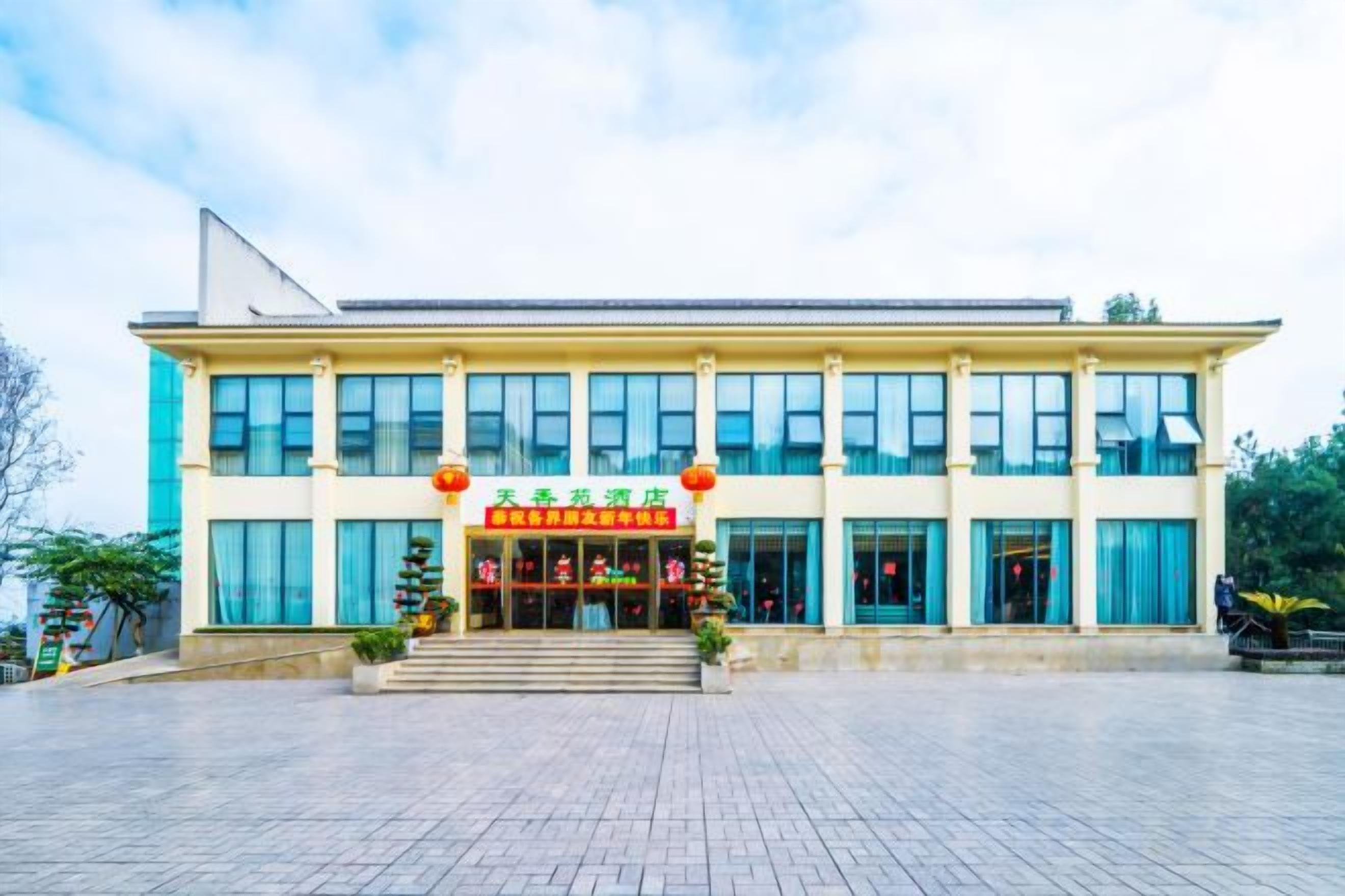 A building with a sign that reads 'Hotel' and a staircase leading to the entrance.