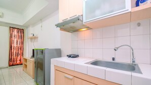 A modern kitchen with a stainless steel sink, a built-in oven, and a microwave.