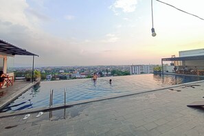 A rooftop pool with a view of the cityscape.