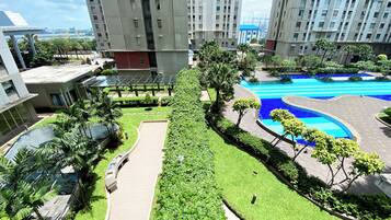 Enjoy a serene atmosphere surrounded by lush greenery and a well-maintained pool.