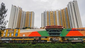 A multi-story building with a prominent sign for "Great Western" and "Grand Serpong Mall" on the facade. - Warm and Minimalist Studio (No Kitchen) at Great Western Apartment (Tangerang)