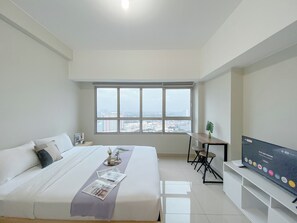 Enjoy a city view from the comfort of this stylish room, featuring a large bed and a flat-screen TV.