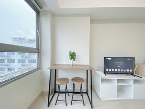Enjoy a city view from the large window, work at the desk with two stools, and unwind with the flat-screen TV.