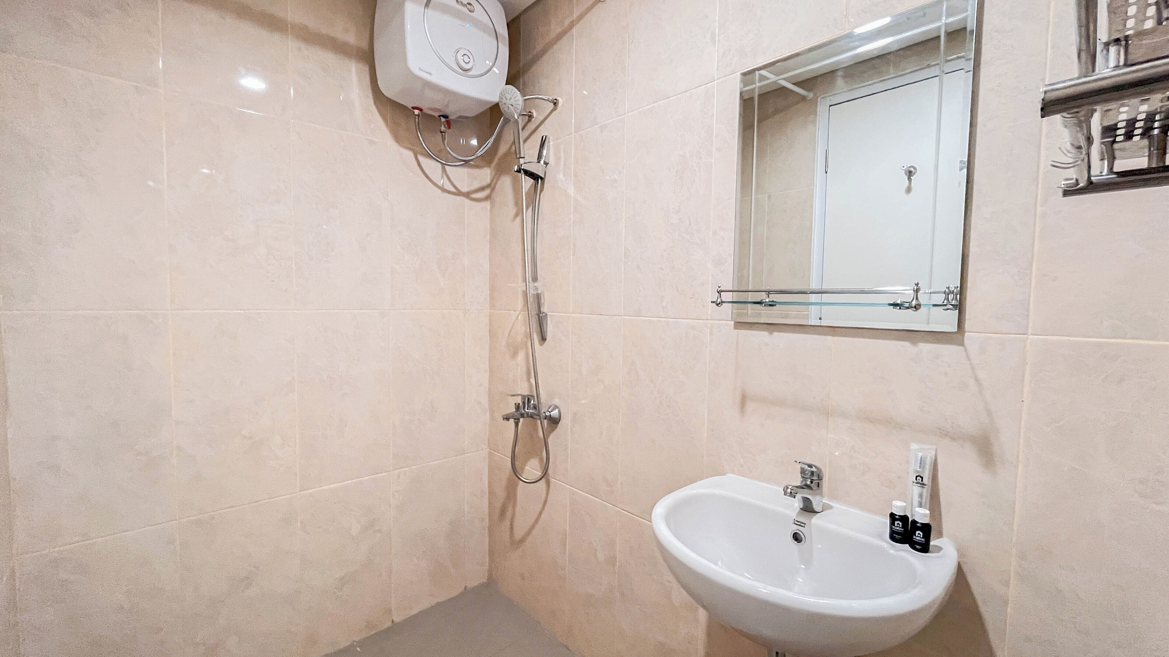Ein Badezimmer mit Dusche, Waschbecken und Spiegel.