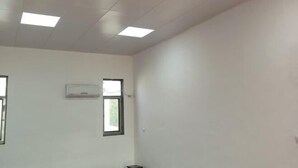 A room with white walls, a ceiling with recessed lighting, an air conditioning unit, and two windows. - YangZhou FuRun Hotel (Yangzhou)