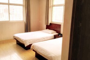 A room with two single beds, wooden flooring, and large windows with curtains. - YangZhou FuRun Hotel (Yangzhou)