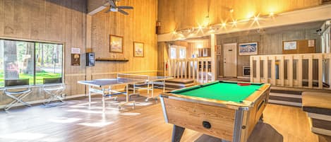 Enjoy pool games and relaxation in this spacious room with a pool table, billiards, and comfortable seating.