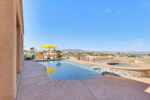 A swimming pool with a hot tub, surrounded by a fence, and overlooking a scenic view. - Lake View & Games: Spacious Oasis in Lake Havasu! (Lake Havasu City)
