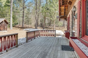 Step out onto the deck and enjoy the serene forest surroundings.