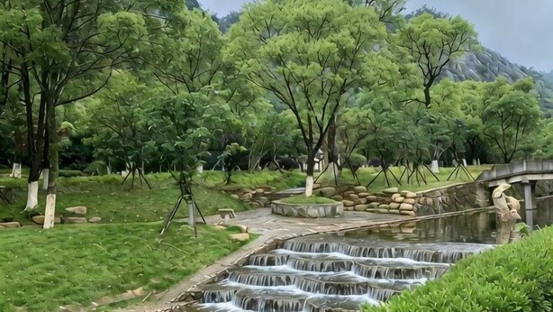 A waterfall, trees, and a stone bridge in a park setting. - Homeinn Fairyland Hotel (Linhai Yintaicheng) (Linhai)