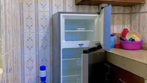 A kitchen with a refrigerator, a sink, and a countertop with various items. - Bondeni Mombasa city (Mombasa)