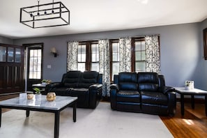 Relax in this stylish living room with a large window, two comfortable sofas, and a cozy coffee table.