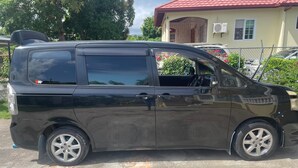 A black van parked on a concrete surface. - 6-bedroom studio in welcoming Ocho Rios with WiFi, AC Escape to Tranquility (Ocho Rios)