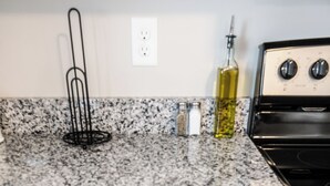 A kitchen drawer with a spatula, scissors, and a spoon.