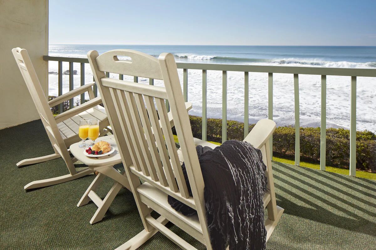 Sip morning juice while waves roll beneath your balcony.