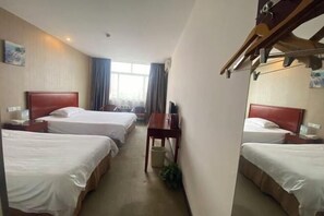 A hotel room with two single beds, a wooden nightstand with a lamp, a desk, and a chair. - Green Tree Alliance Hotel (Shanghai East Jinxiu Road) (Shanghai)