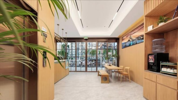 A modern hotel lobby with a reception desk, seating area, and large windows offering a view of the cityscape. - Super 8 Preferred Hotel（Mentougou Xinqiao Street Branch Conversion） (Beijing)