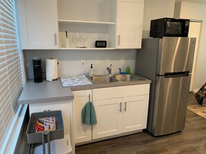 Fridge, microwave, coffee/tea maker, cookware/dishes/utensils