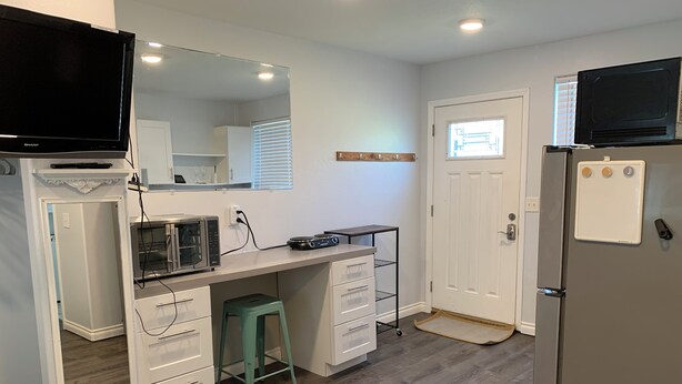 A compact kitchen with a microwave, toaster, and refrigerator. - Studio in The Heart of Soldotna (Soldotna)