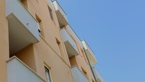 A multi-story building with balconies, a clear sky, and a window on the lower level. - SE156 – Senigallia, three-room apartment a few steps from the sea (Senigallia)