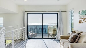 A balcony with a view of the sea, a white railing, a sofa, and a wall with a mermaid decoration. - 2 Oceanfront Homes w/ Rooftop Deck, Views & Steps to the Sand (Oceano)
