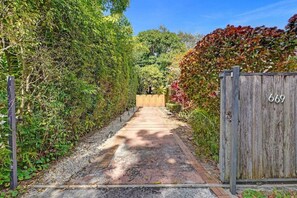 A pathway leading to a wooden gate with the number 669.