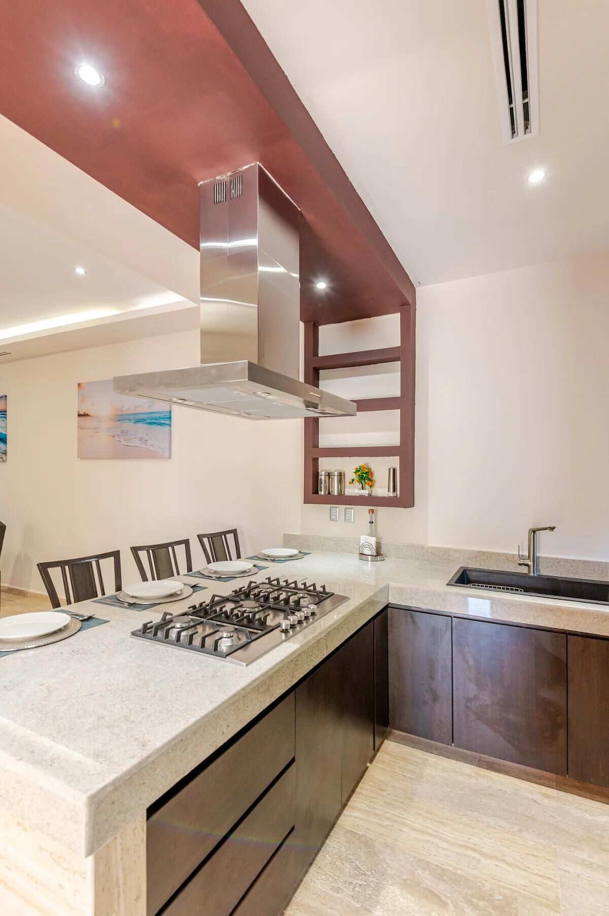 Una cucina moderna con isola centrale, piano cottura integrato e lavello.