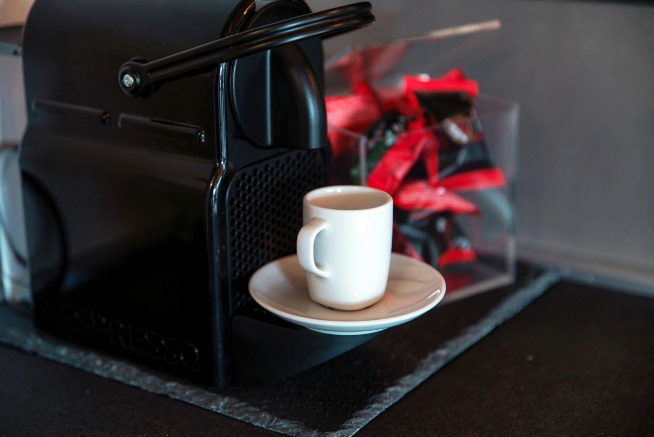 A coffee machine with a cup on a saucer.
