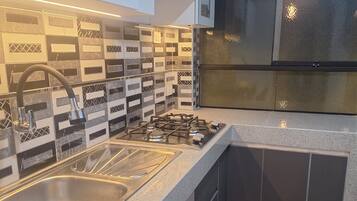 Fridge, microwave, electric kettle, cookware/dishes/utensils