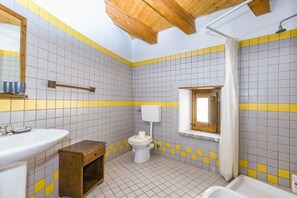 A bathroom with a sink, toilet, shower, and wooden beams on the ceiling. - 'Writer's Room' with Balcony (San Marco D'alunzio)