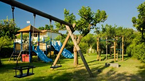 A playground with swings, a slide, and a climbing structure. - Room 'Ninetta' with Mountain View, Wi-Fi and Air Conditioning (Taormina)
