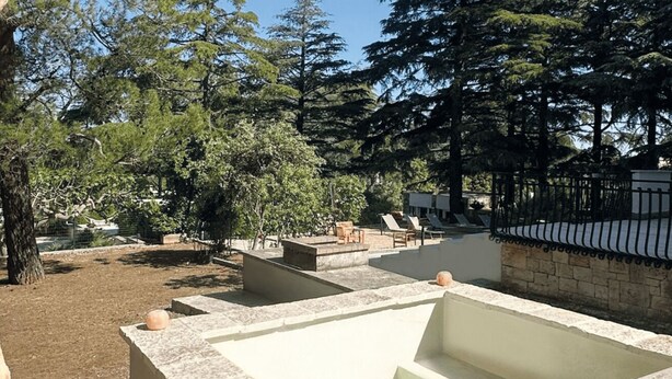 Un espace bien-être comprenant un jacuzzi, des chaises longues et une piscine.