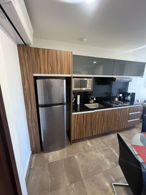 Fridge, microwave, stovetop, coffee/tea maker