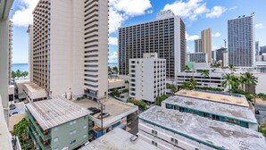 A high-rise hotel with multiple floors, a rooftop terrace, and a view of the ocean. - Legal Studio with AC and WiFi, Just One Block from Waikiki Beach (Honolulu)