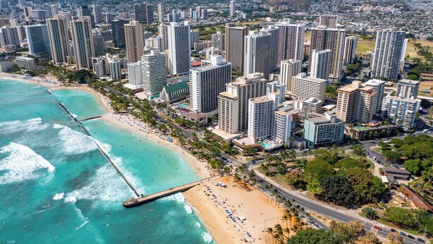 A coastal cityscape with high-rise buildings, a beach, and a pier. - Legal Studio with AC and WiFi, Just One Block from Waikiki Beach (Honolulu)
