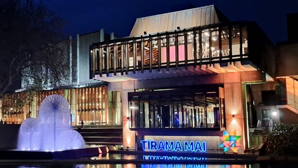A modern building with a prominent sign reading "TIRAMA MAI".