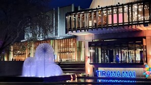 A modern building with a sign reading "TIRAMA MAI".