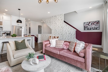 Open-floor living space featuring a smart TV and designer furnishings. (2nd Floor)