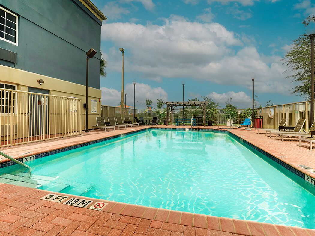 Dive into sunshine by the sparkling pool and loungers.