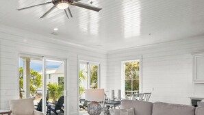 A spacious living room with a ceiling fan, large windows, and a view of the marina. - The Osprey 12-Bayfront w/ boat slip, elevator, & pool. Sapphire Osprey by Kaiser (Orange Beach)