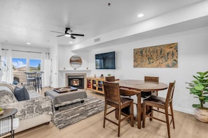 Una sala de estar moderna con chimenea, mesa de comedor y asientos cómodos.